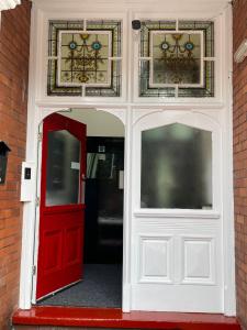 an open door with a red door and windows at ISUITES in Newcastle under Lyme