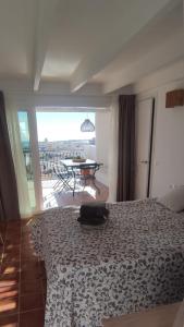 a bedroom with a bed and a view of a patio at Casa Lucia the most beautiful views sea and city in Alicante