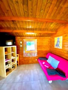 a room with a pink couch in a wooden room at Canary Wild House 2 in Carrizal