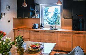 a kitchen with a table with a bowl of fruit on it at Awesome Apartment In Stezyca With Sauna in Stężyca