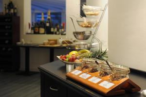 a bowl of fruit on a counter with a bowl of fruit at Ambassador Parkhotel in Munich