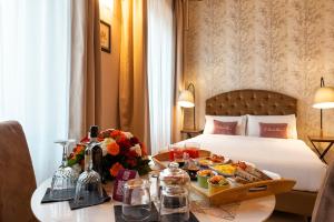 a hotel room with a tray of food on a table at Le Suite del Barone in Rome +36 photos