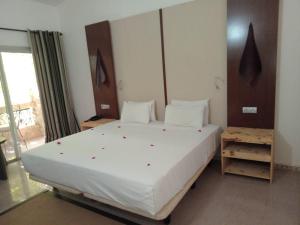 a bedroom with a large white bed in a room at Iris Hotel in Dakar