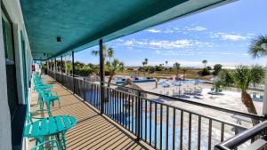 a balcony with chairs and a view of the beach at Tahitian Beach Resort in St. Pete Beach