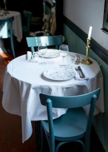 a table with wine glasses and a candle on it at Chez Marie in Linguizzetta