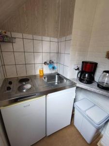 a small kitchen with a sink and a counter at Ferienwohnung Katharina in Stolberg (Harz) in Stolberg