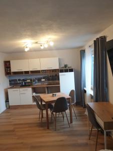 a kitchen and dining room with a table and chairs at Ferienwohnung Luitpold 2 in Memmingen