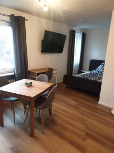 a room with a table and chairs and a bed at Ferienwohnung Luitpold 2 in Memmingen