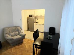 a living room with a chair and a table at Apartment Bitola in Bitola
