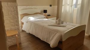 a bedroom with a large white bed with towels on it at Albergo la Svolta in Brescia