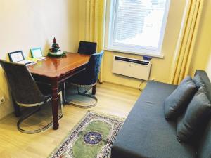 a living room with a table and a couch at 3min walk to Vilnius business center in Vilnius
