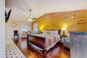 a bedroom with a bed and a wooden wall at Ozark Spring Cabins - Mountain View 01 in Eureka Springs