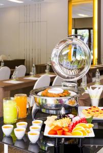 a buffet of food and drinks on a table at Ibis Bangkok Riverside in Bangkok