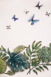 a painting of butterflies flying around a plant at Ferienhaus an der Wiederitz in Freital