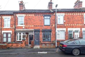 a brick house with a car parked in front of it at Chorlton House by Truestays - NEW 2 Bedroom House in Stoke-on-Trent in Hanley
