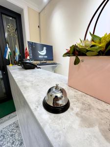 a reception desk with a clock on top of it at NEST INN in Tashkent