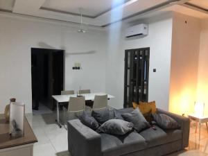 a living room with a couch and a table at PARADISE HY in Cotonou