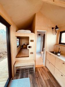 a tiny house with a kitchen and a sink at Kråen Gard in Larsnes