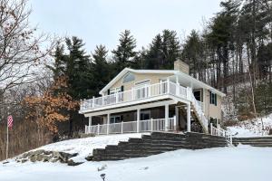 a house on a hill in the snow at Deer Run Retreat in Gilford