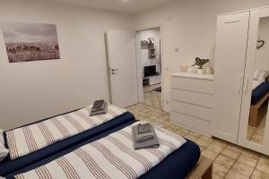a room with two beds and a kitchen in it at Ferien-/Monteurwohnung im Odw. in Mörlenbach