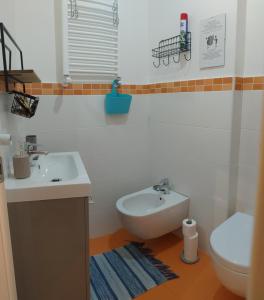 a bathroom with a sink and a toilet at VentoVerde B&B in Albenga