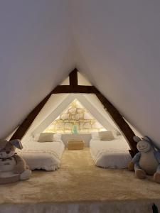 a room with four beds in a attic at Tiny housse la Poitevinière in Neuillé