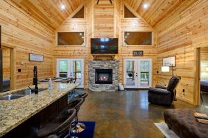 a log cabin living room with a fireplace at Crystal Moon in Broken Bow