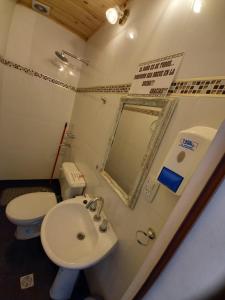 a bathroom with a sink and a toilet and a mirror at Corral de Piedras in Humahuaca +11 photos