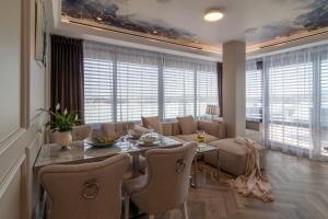 a dining room and living room with a table and chairs at Sky Roof Apartments in Bielsko-Biala