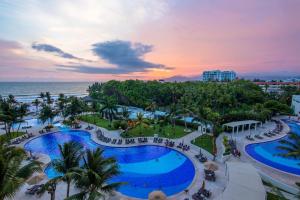 an aerial view of a resort with a pool and the ocean at Breathtaking Villa Magna Beachfront Condo 3 Bedrooms Sleeps 6 in Nuevo Vallarta 
