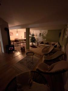 a living room with a couch and a christmas tree at Malinowa Chata in Cisna