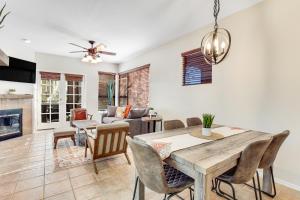 a dining room and living room with a table and chairs at Canyon Crest Condo in Tucson