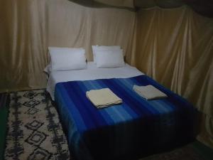 Кровать или кровати в номере Merzouga Activities Camp