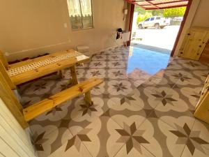 a hallway with a bench and a tile floor at Casa- Encanto da Praça in Urupema