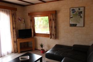 a living room with a couch and a window at Chalet du Lièvre in Hannappes