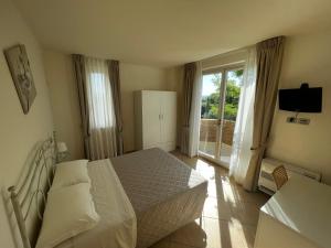a bedroom with a bed and a large window at Parco Fibonacci in Montefano