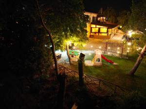 a backyard at night with a playground and a house at Masseria La Guardata in Guglionesi