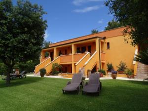 a building with two chairs on the lawn at Sole del Mediterraneo in Otranto