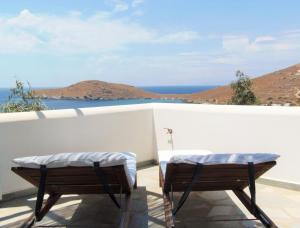 two beds on a balcony with a view of the ocean at 'Paradise' by Cnn - Delfini Bay - 3Bed House in Ano Syros