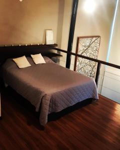 a bedroom with a bed and a large window at Loft de Montaña in Río Ceballos +76 photos
