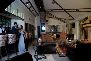 a bride and groom standing at a bar in a living room at Archontopetra Boutique Hotel in Megalo Chorio