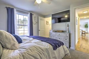 a bedroom with a bed and a dresser and a window at NEW! Updated Mystic Home w/ Sauna, Hot Tub & Deck in Mystic