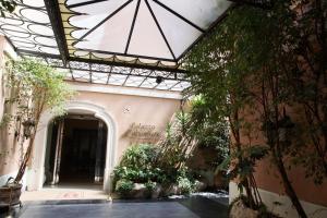 a building with a glass ceiling with plants in it at Palazzo Alabardieri in Naples