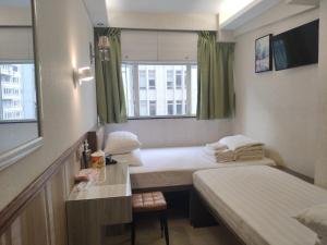 A bed or beds in a room at Celltronik Hostel 先創旅店