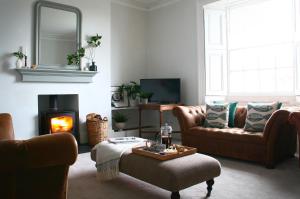 a living room with two couches and a fire place at Beautiful 6-Bed House in Lynton North Devon in Lynton