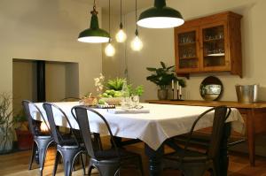 a dining room with a table with chairs and lights at Beautiful 6-Bed House in Lynton North Devon in Lynton