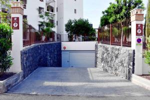 a garage door in a building with a fence at Ancor 0-3 POOL VIEW 1B in Palm-mar