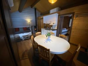 a dining room and kitchen with a table and chairs at Camping Fredrika-Braber in Fredrika