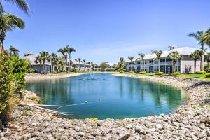 a pool at a resort with palm trees at Beautiful Naples Golf Villa in Famous Lely Resort! in Naples