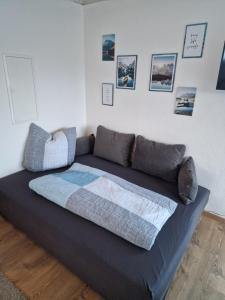 a large bed in a room with pictures on the wall at Appartement Lurger in Kirchberg in Tirol